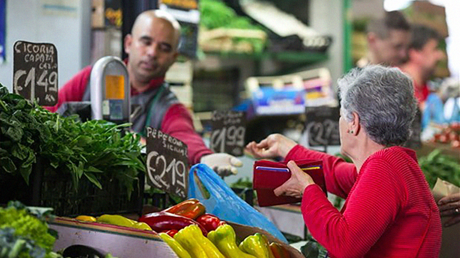 old lady buying fruits and vegetables in the market